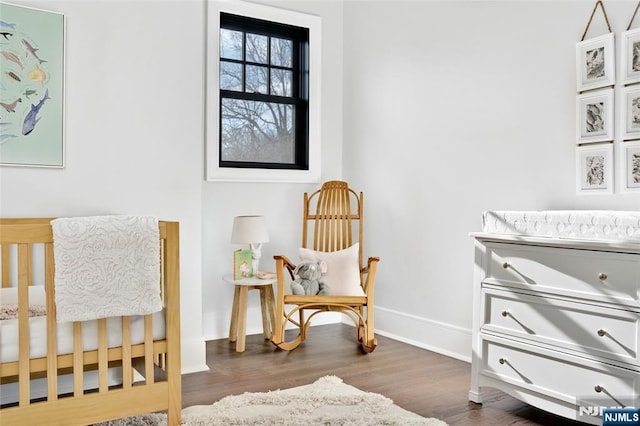 sitting room with dark wood-type flooring