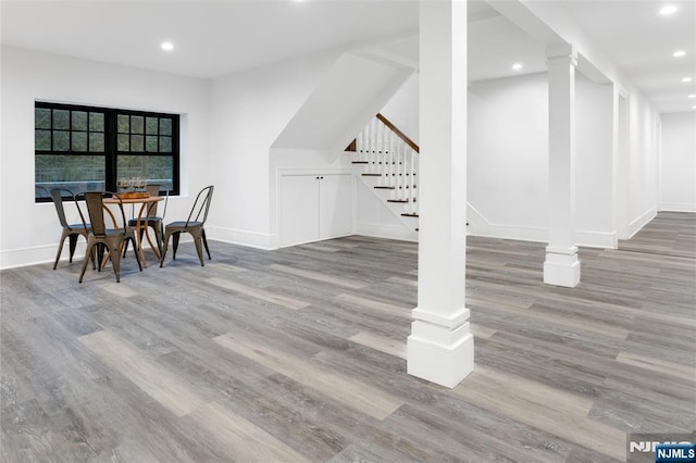 dining space with hardwood / wood-style flooring and ornate columns