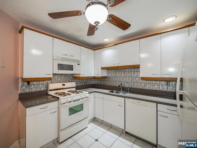 kitchen featuring tasteful backsplash, white appliances, sink, and white cabinets