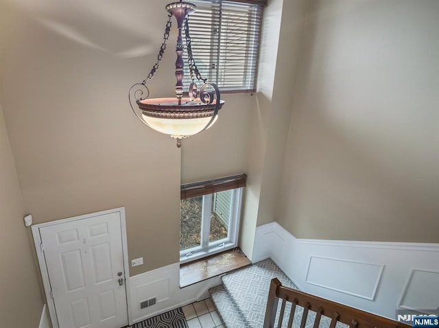 entrance foyer with tile patterned floors and a wealth of natural light