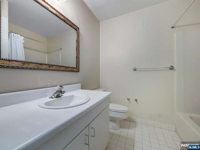 bathroom featuring vanity, tile patterned floors, and toilet