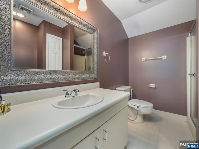 bathroom with vanity, vaulted ceiling, and toilet