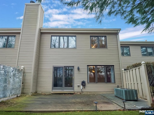 back of house featuring central AC unit and a patio