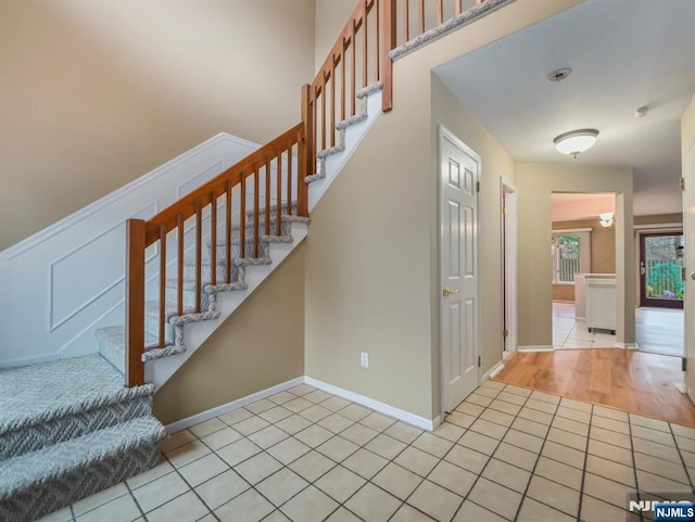 staircase with tile patterned floors