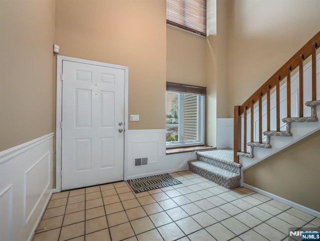 tiled entryway with a high ceiling