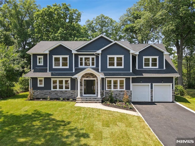 craftsman inspired home with a garage and a front yard