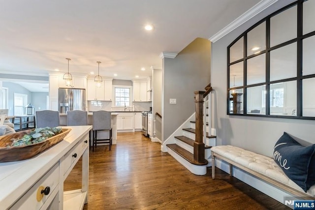 interior space with crown molding and dark wood-type flooring