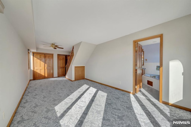 interior space with ceiling fan and carpet floors