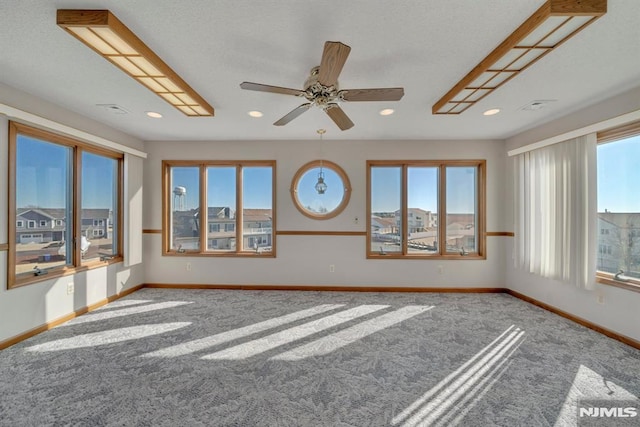 unfurnished room featuring carpet floors and ceiling fan