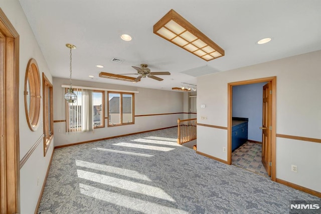 carpeted spare room with ceiling fan