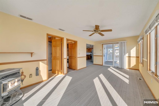 interior space featuring heating unit and ceiling fan