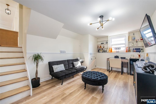 sitting room with an inviting chandelier and light wood-type flooring