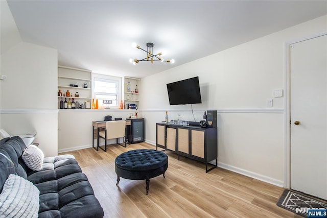 living room featuring an inviting chandelier and wood-type flooring