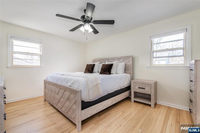 bedroom with light hardwood / wood-style flooring and ceiling fan