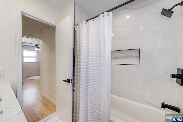 bathroom featuring ceiling fan, shower / tub combo, and hardwood / wood-style floors