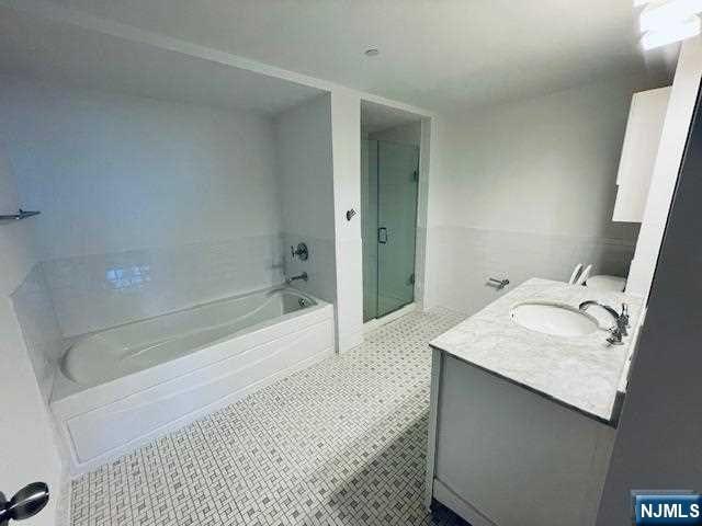 bathroom featuring vanity, separate shower and tub, and tile patterned flooring