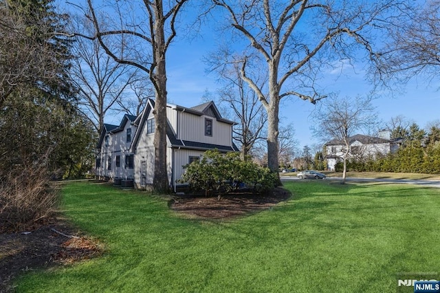 view of side of home with a lawn