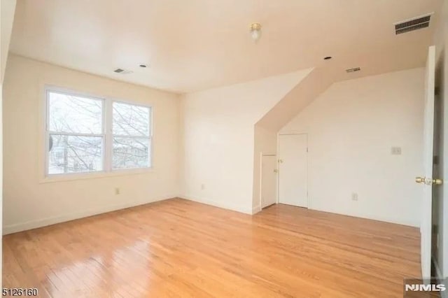 bonus room featuring visible vents and light wood finished floors