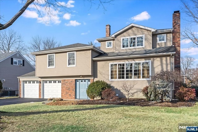 view of front of house featuring a garage and a front lawn