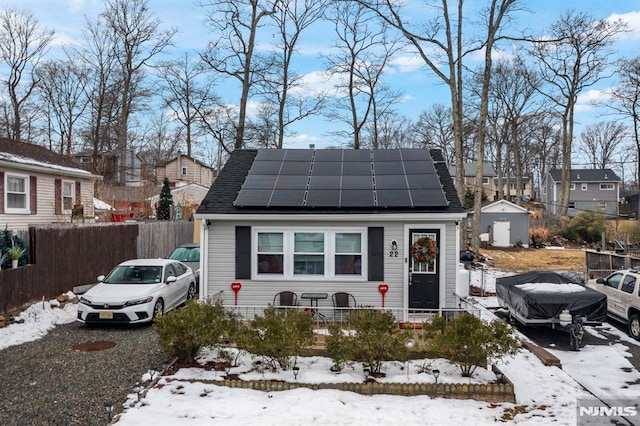 view of front of property featuring solar panels