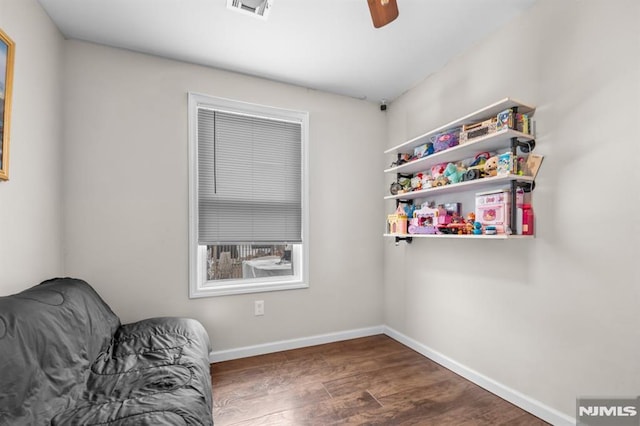 sitting room with ceiling fan and dark hardwood / wood-style flooring