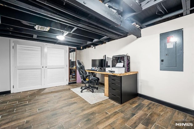 office with dark hardwood / wood-style floors and electric panel