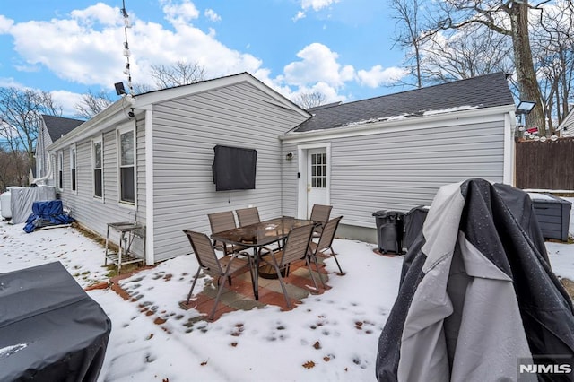 view of snow covered rear of property