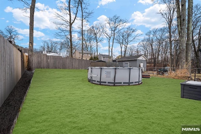 view of yard with a fenced in pool