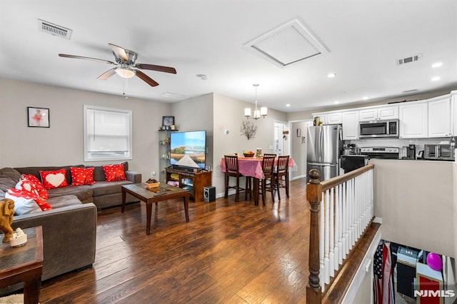 living room featuring dark hardwood / wood-style flooring and ceiling fan