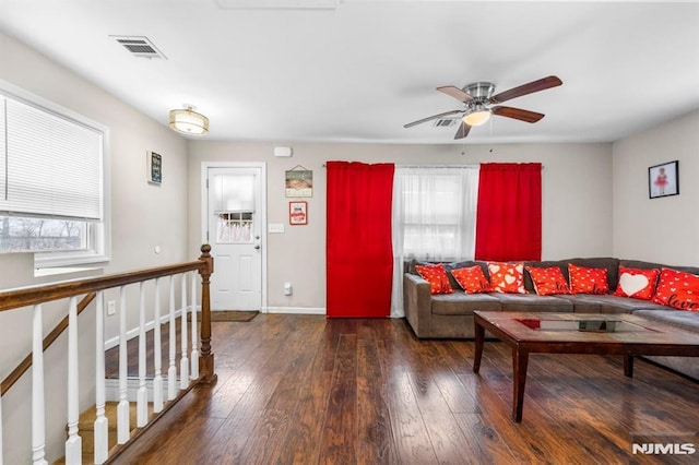 living room with ceiling fan and dark hardwood / wood-style flooring