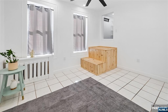 interior space featuring tile patterned floors and ceiling fan