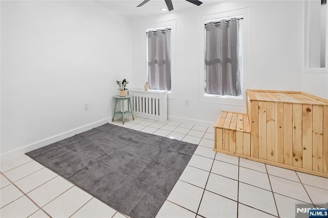 spare room featuring light tile patterned floors and ceiling fan