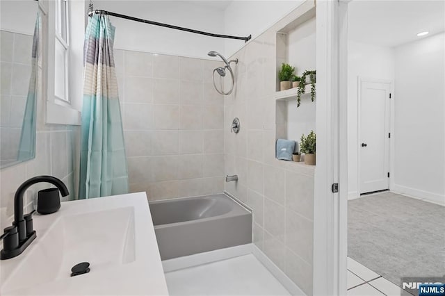 bathroom featuring sink and shower / bathtub combination with curtain