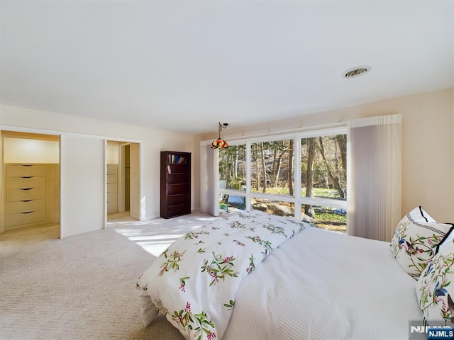 bedroom featuring light carpet and visible vents