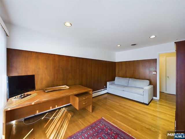 office area featuring light wood finished floors, visible vents, a baseboard heating unit, and recessed lighting