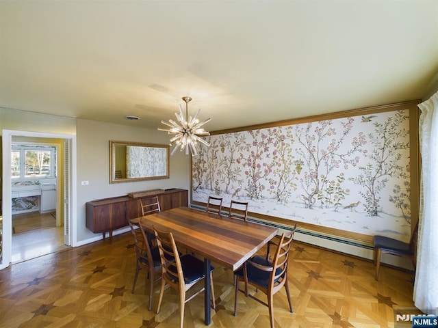 dining room with baseboards and a notable chandelier