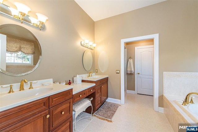 bathroom featuring vanity and tiled tub