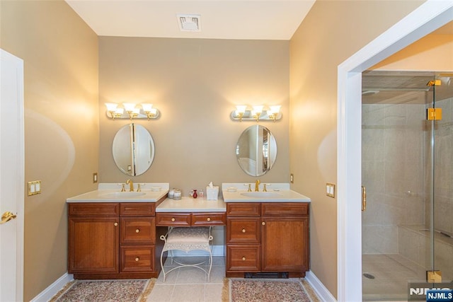 bathroom featuring vanity, tile patterned flooring, and walk in shower