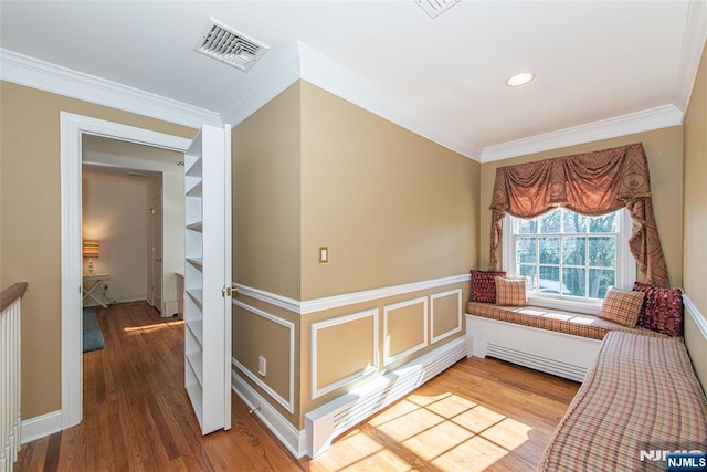 interior space featuring crown molding and hardwood / wood-style floors