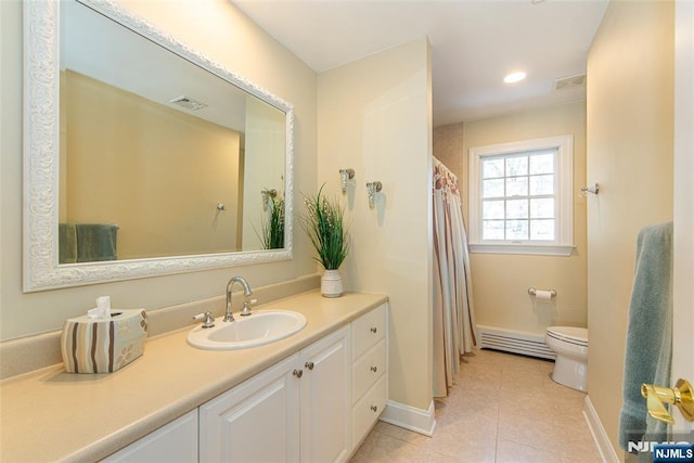 bathroom with vanity, a baseboard heating unit, tile patterned floors, and toilet