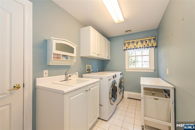 laundry room featuring sink, cabinets, washing machine and clothes dryer, and light tile patterned flooring