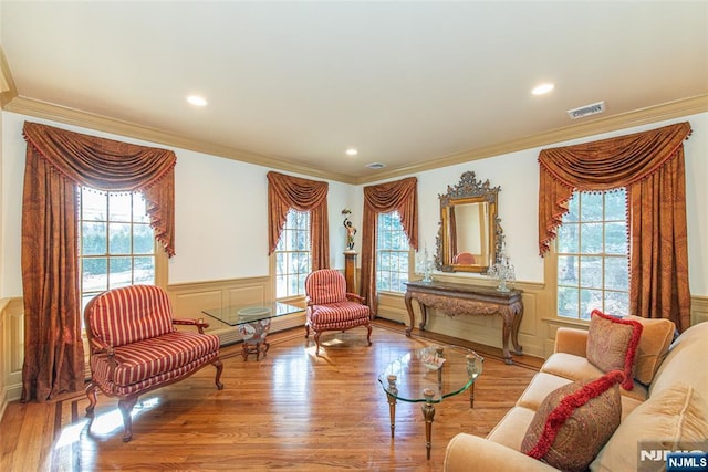 sitting room featuring light hardwood / wood-style flooring and ornamental molding