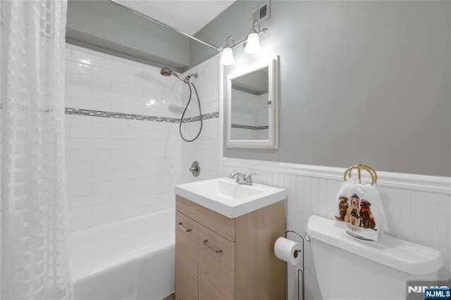 full bathroom with toilet, vanity, and shower / bathtub combination with curtain