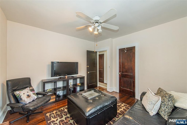 living room featuring dark hardwood / wood-style floors and ceiling fan