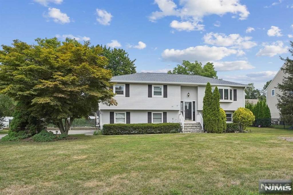 split foyer home with a front lawn