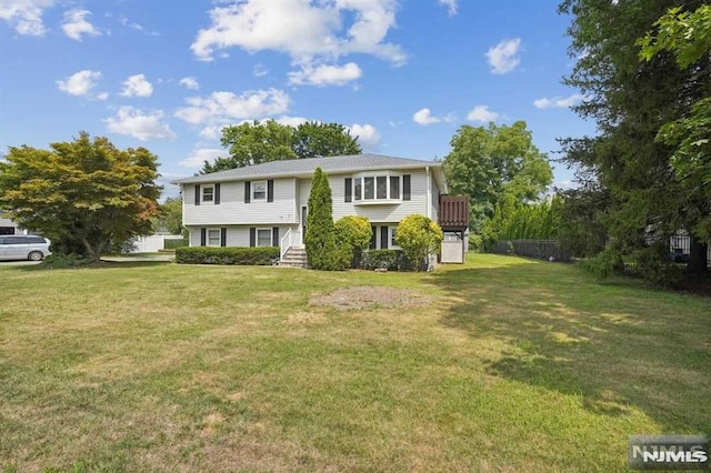 split foyer home with a front lawn