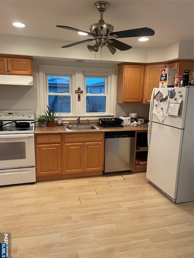 kitchen featuring sink, white appliances, light hardwood / wood-style flooring, and ceiling fan