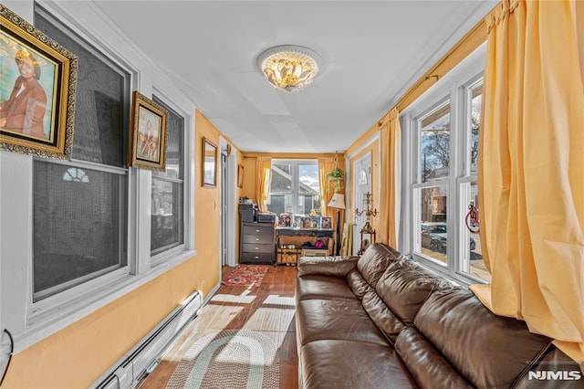 sunroom with a baseboard heating unit