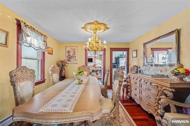 dining space featuring baseboard heating, dark hardwood / wood-style floors, and a chandelier