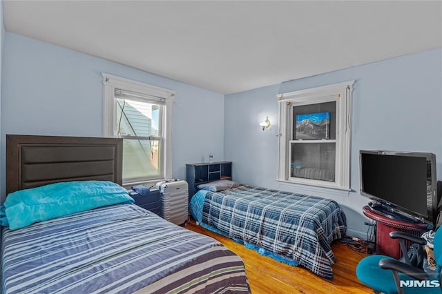 bedroom with hardwood / wood-style flooring